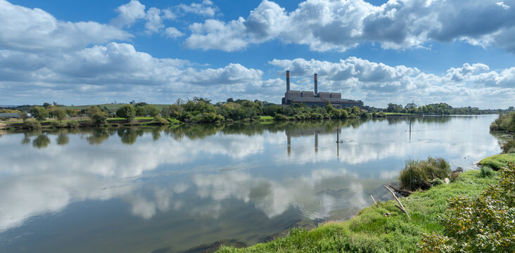 An aerial view of the Huntly Power Station, a thermal power plant in Huntly, New Zealand, situated on the Waikato River. The plant is a significant source of electricity generation for the country.