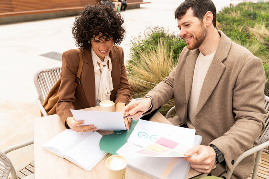 Coworkers Reviewing Documents Outdoors