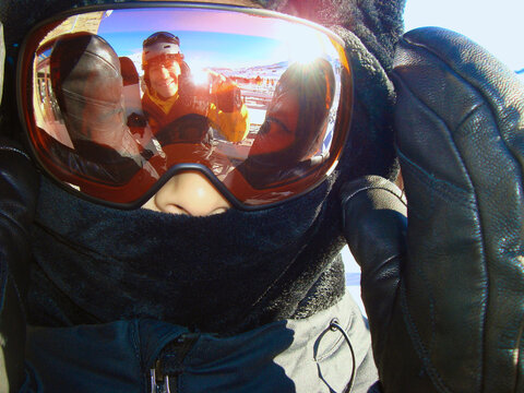 Snowboarder Self Portrait in Goggles with Mountain Reflection