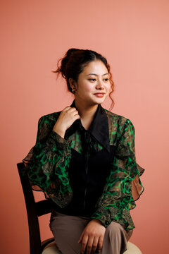 Woman Poses for a Studio Portrait With a Plain Background