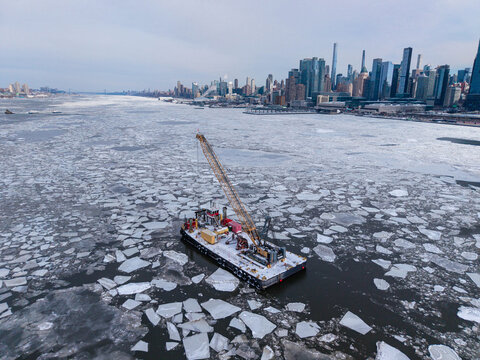 Floating crane platform among ice near Manhattan
