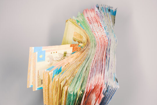Stack of Various Banknotes From Different Countries on a Gray Surface