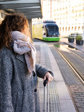 Woman traveling waiting for tram at station