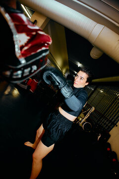 Female Boxer Training in Gym with Boxing Gloves
