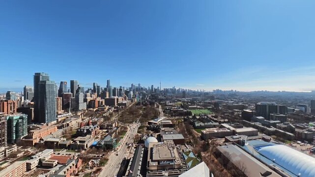 Toronto Aerial view of modern urban cityscape with skyscrapers, highways, and mixed-use development under clear blue sky
