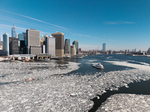 Frozen harbor with ferries and Manhattan skyline
