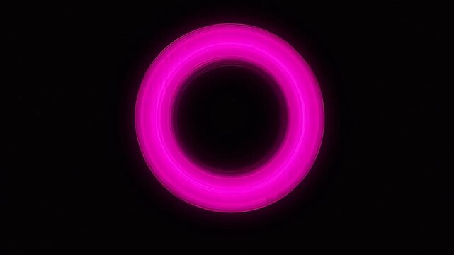 Pink glowing ring in dark space emphasizing natural beauty and tranquility