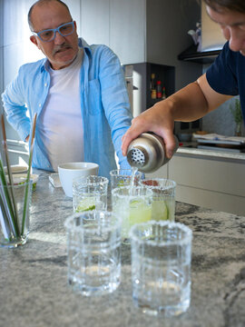 Gay Couple Prepare Cocktails in a Modern Kitchen for NYE Party