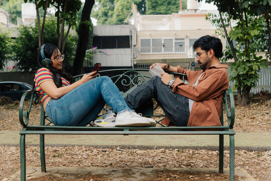 Young couple relaxing on a park bench.
