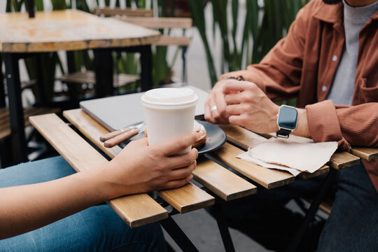 Two unrecognizable people in a cafe.