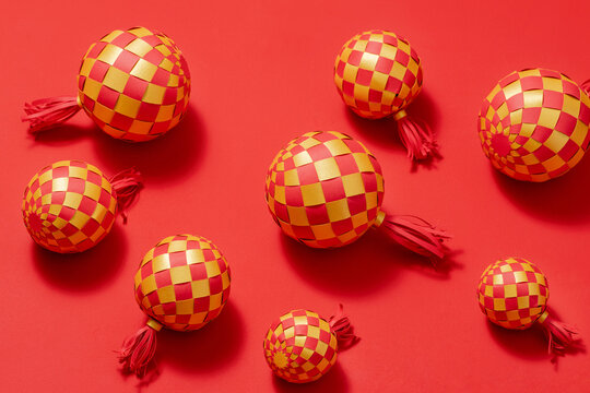 Decorative red and gold woven spheres on a vibrant red background