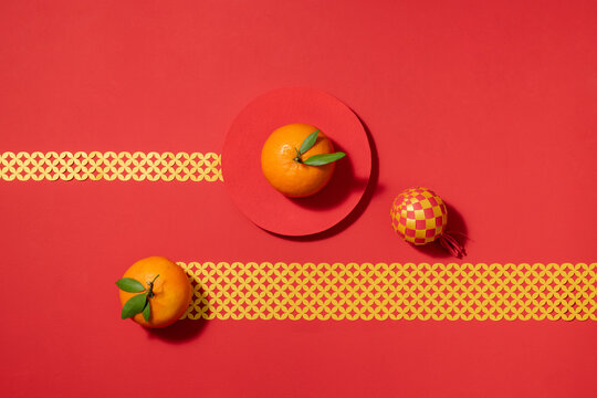 Festive Chinese New Year still life with oranges on red background