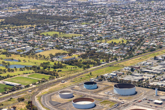 williamstown north aerial view suburb city residential area industrial site water tanks greenery roads parks urban landscape infrastructure victoria australia