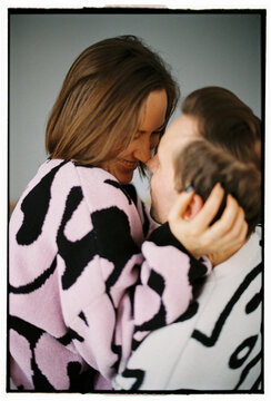 Close-up of smiling couple embracing affectionately