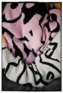 Close-up of cozy couple embrace in patterned sweaters