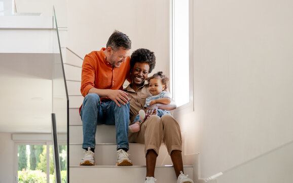 Family enjoying quality time on a bright staircase