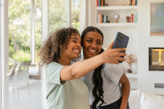 Friends taking a selfie together in a cozy living room