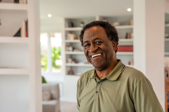 Elderly man smiling warmly in a cozy living room
