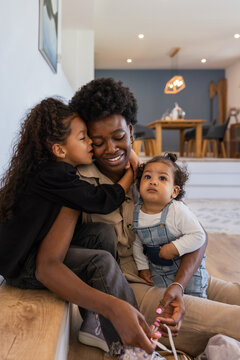 Family bonding moment at home with mother and daughters