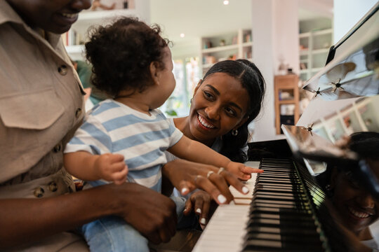 Smiling family enjoys a piano music session
