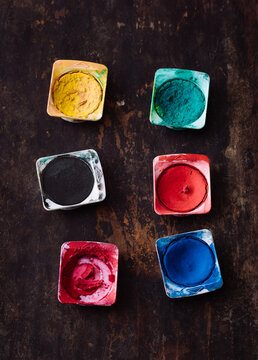 palette for watercolors on a wooden table with colorful paint