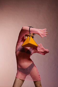 Pink Knit Dress With Orange Pyramid Bag