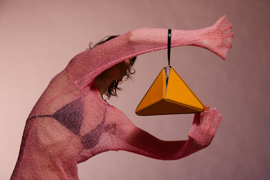 Bold Pink Knit Sweater With Orange Triangular Bag