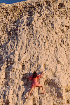 Young Climber On Rocky Cliff