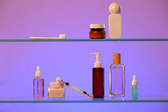 Various skincare and beauty products arranged on glass shelves