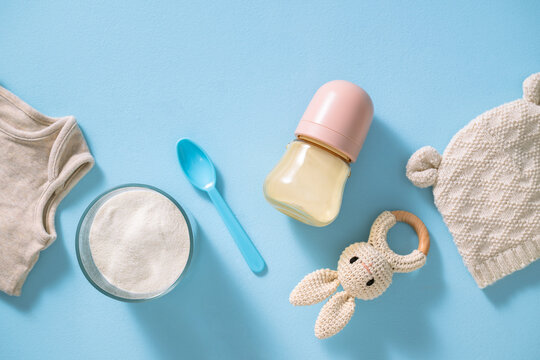 Baby feeding essentials laid out on a blue background