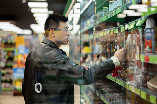 Chinese Man Shopping for Groceries in Supermarket