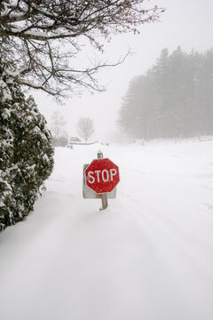 stop sign almost buried in snow