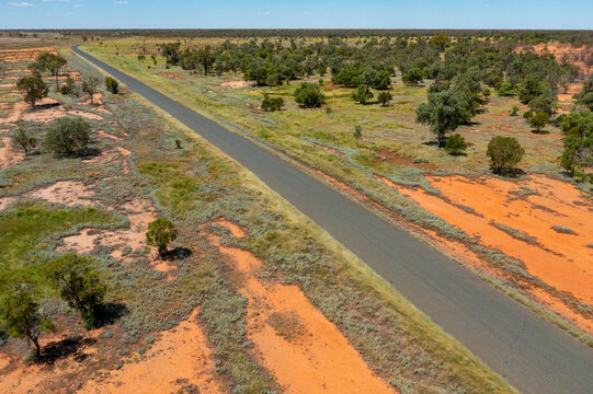 Long straight road running through a remote outback landscape