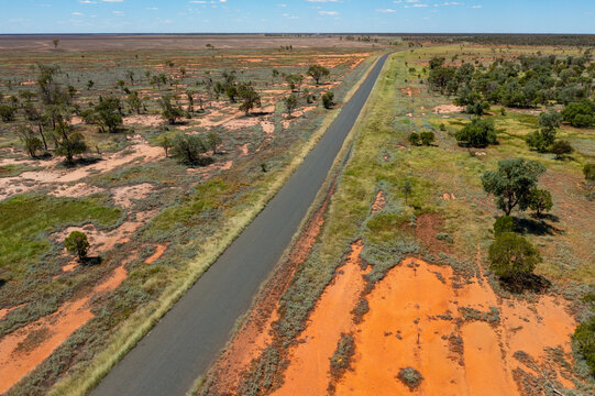 Long straight road running through a remote outback landscape