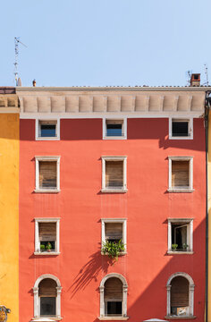 Red Building Facade with Shutters in Riva del Garda Italy