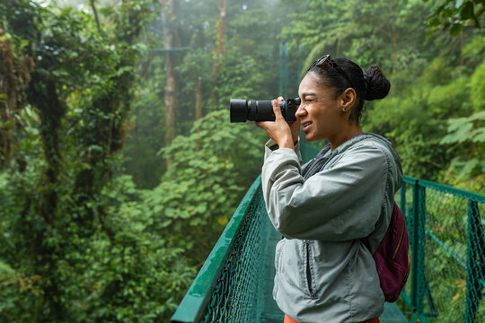 Tourist taking photographs of biodiversity in the rainforest
