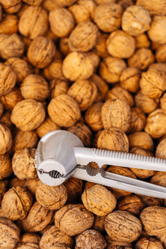 Whole walnuts with metal nutcracker