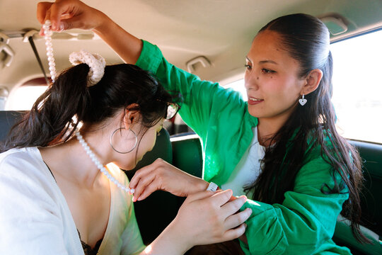 Fastening Pearl Necklace in Backseat
