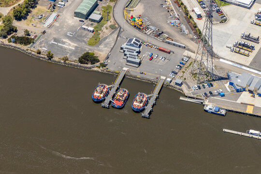 port melbourne aerial view tugboats dock waterfront industrial area parking lot marina boats cargo shipyard harbor victoria australia