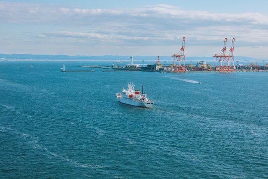 Harbor Twilight: A Vessel Gliding Through the Serene Blue Sea.
