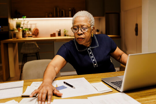 Senior woman managing finances and planning retirement at home