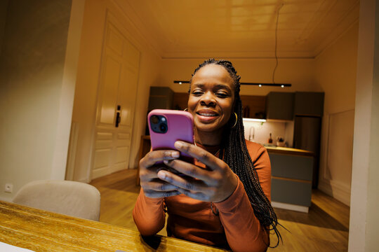 Woman using smartphone for communication at home