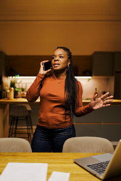 Woman communicating on smartphone in the kitchen