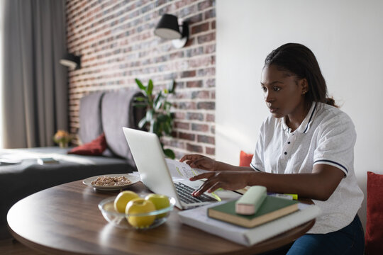 Black student using laptop at home