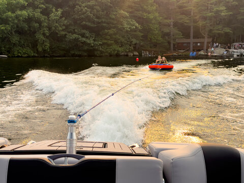 Family together tubing at lake in Maine 