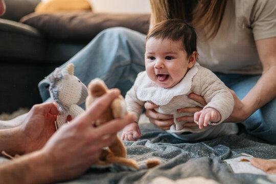 Family playing with baby at home creating happy loving moments