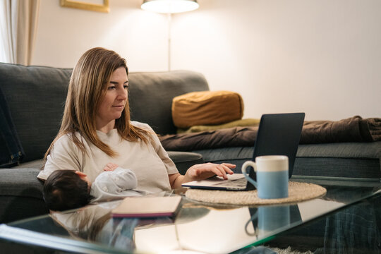 Parent working remotely from home while caring for infant