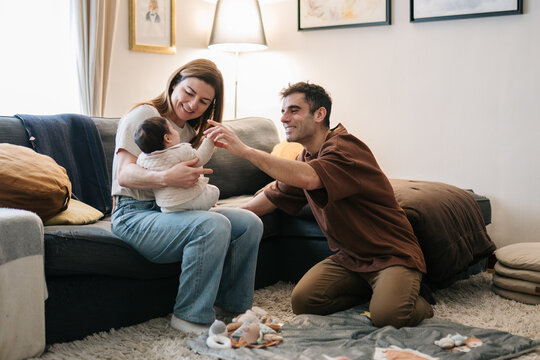 Parents bonding with baby at home in living room