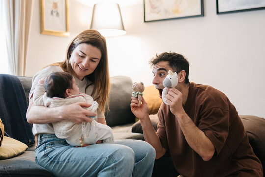 Family playing with baby at home enjoying parenthood moments