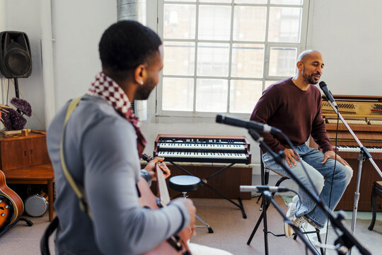 Musicians performing music in studio rehearsal session